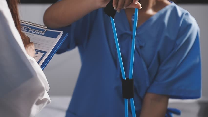 Physical therapist working with patient on upper extremity exerc