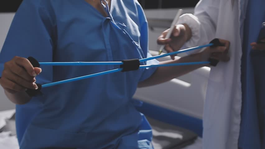 Physical therapist working with patient on upper extremity exerc