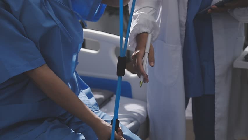 Physical therapist working with patient on upper extremity exerc