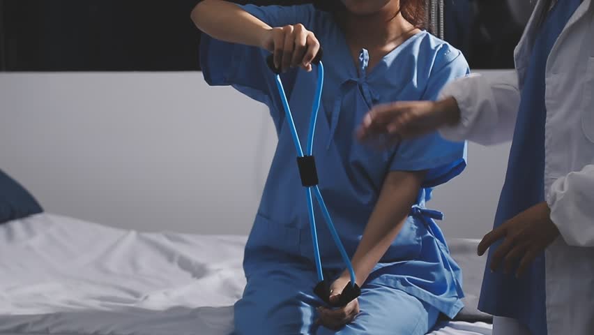 Physical therapist working with patient on upper extremity exerc