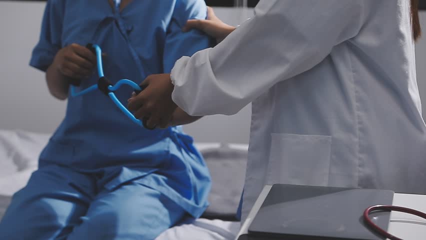 Physical therapist working with patient on upper extremity exerc