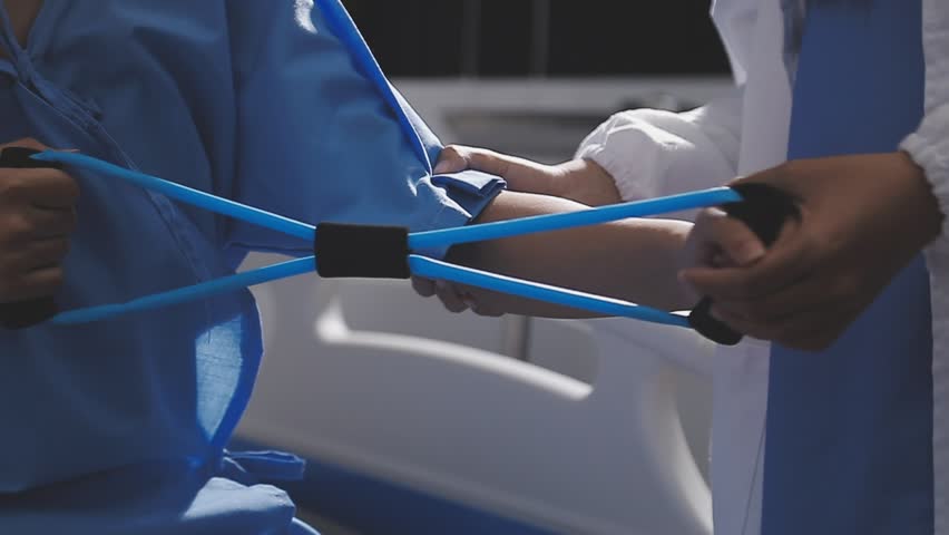 Physical therapist working with patient on upper extremity exerc