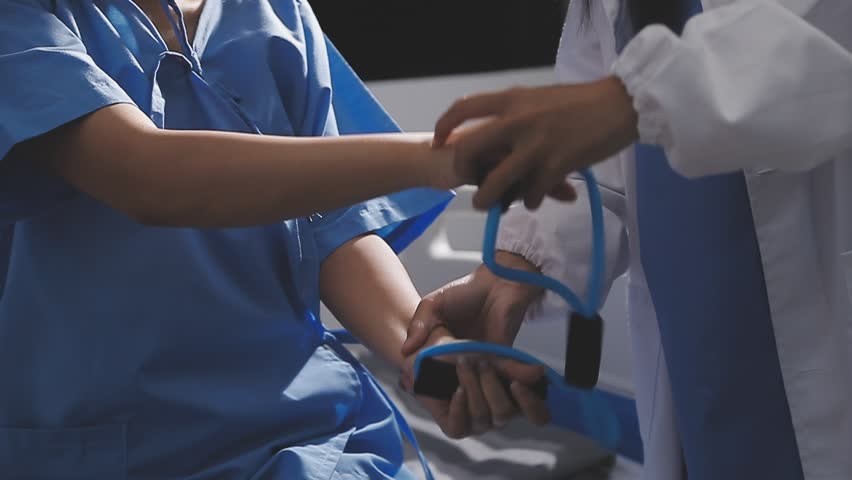 Physical therapist working with patient on upper extremity exerc