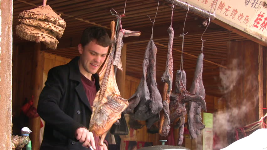 Cook in China. European man is preparing chinese food March 2009