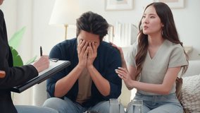 Young asian couple experiencing marriage counseling, wife comforting partner while talking with psychologist for mental health and consultation, examining health with anxious, medical and couple. - Powered by Shutterstock - Get 15% off with code: PIKWIZARD15