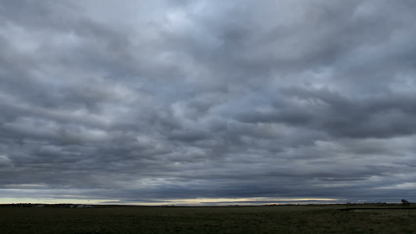 Wide angle storm clouds flying over an open landscape. HD 1080p time lapse.