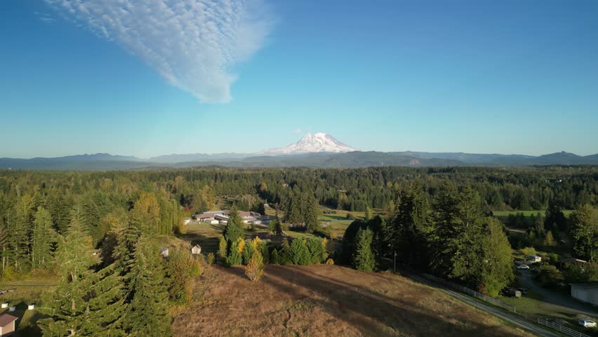 Dramatic drone shot of Lake Superior shoreline with autumn trees and rippling waves in Michigan’s Upper Peninsula