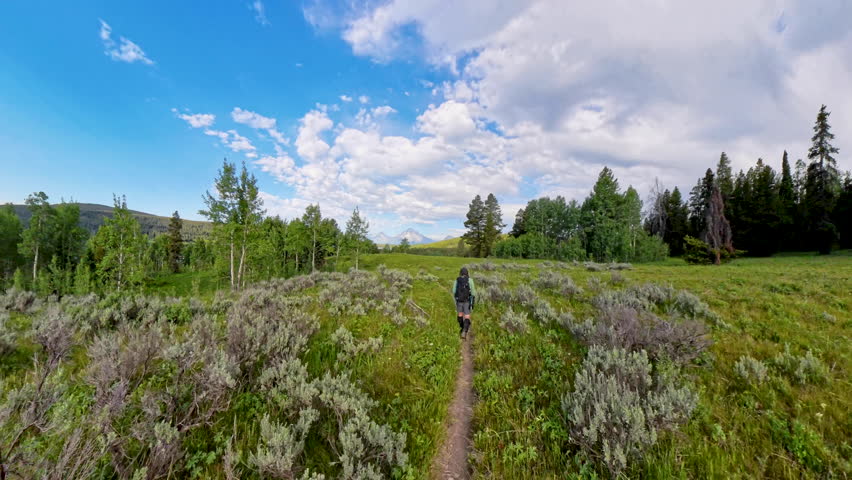 High Angle view of Man Hiking Toward Tetons In Grand Teton National Park
