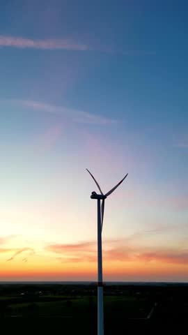 A stunning view of a wind turbine at sunset, highlighting the significance of renewable energy today