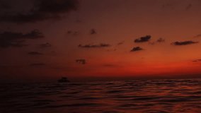 Amazing sunset with vivid orange skies in Thailand, Koh Kood island. Boat drifts in the distance, creating peaceful and dreamy tropical scene filled with warmth and serenity. Vacation vibes background - Powered by Shutterstock - Get 15% off with code: PIKWIZARD15