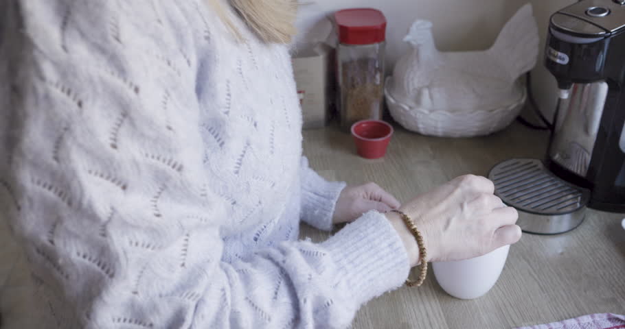 Mature woman, coffee cup and thinking with smile, happy and relax in kitchen in home. Retirement, mature lady and elderly female with hot beverage, being content and nostalgia memories with tea mug,