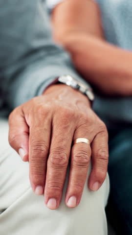Holding hands, senior couple and support with comfort, home and compassion with relationship. Closeup, gratitude and man with woman, apartment and kindness with empathy, retirement and marriage