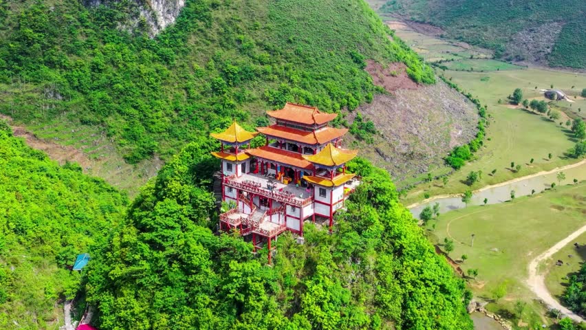 Aerial View of Mountaintop Temple in Lush Green Valley