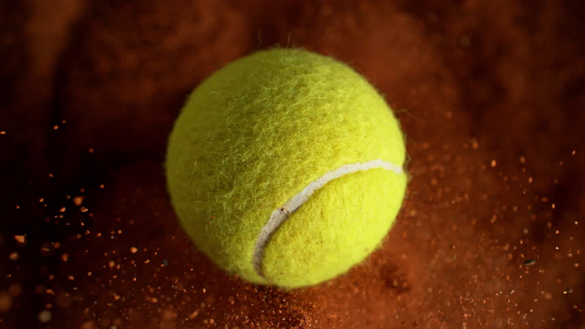 Super Slow Motion Flying Tennis Ball and Orange Clay Explosion Towards Camera at 1000fps.