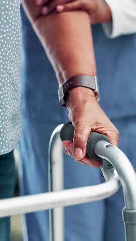Nurse, senior person and help with walker for balance, steps and healing with physiotherapy at clinic. People, caregiver and patient with disability, frame and rehabilitation process for recovery