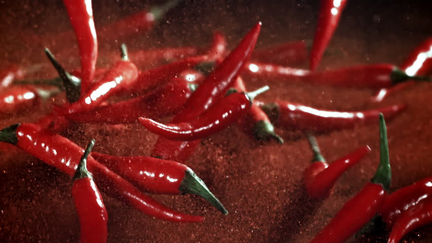 Red chili pepper in flight with ground pepper. Filmed on a high-speed camera at 1000 fps. High quality FullHD footage