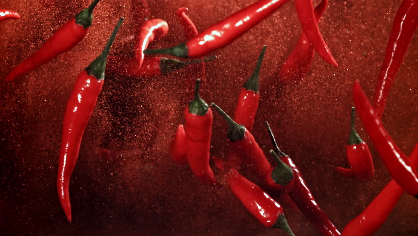 Red chili pepper in flight with ground pepper. Filmed on a high-speed camera at 1000 fps. High quality FullHD footage