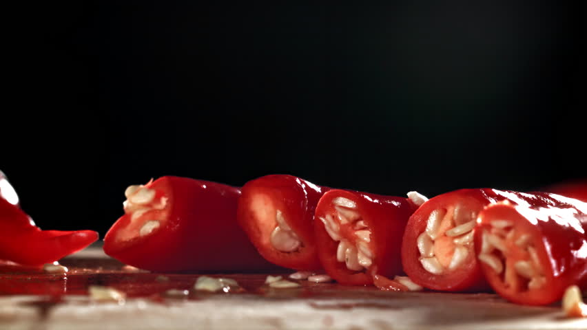 Slicing red chili peppers. Filmed on a high-speed camera at 1000 fps. High quality FullHD footage