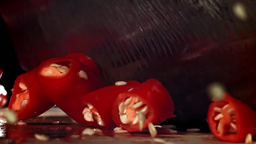 Slicing red chili peppers. Filmed on a high-speed camera at 1000 fps. High quality FullHD footage
