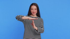 Tired serious upset young woman showing time out gesture, limit or stop sign no pressure, I need more time. Pretty brunette adult girl bored of work wishing to have a break isolated on blue background - Powered by Shutterstock - Get 15% off with code: PIKWIZARD15