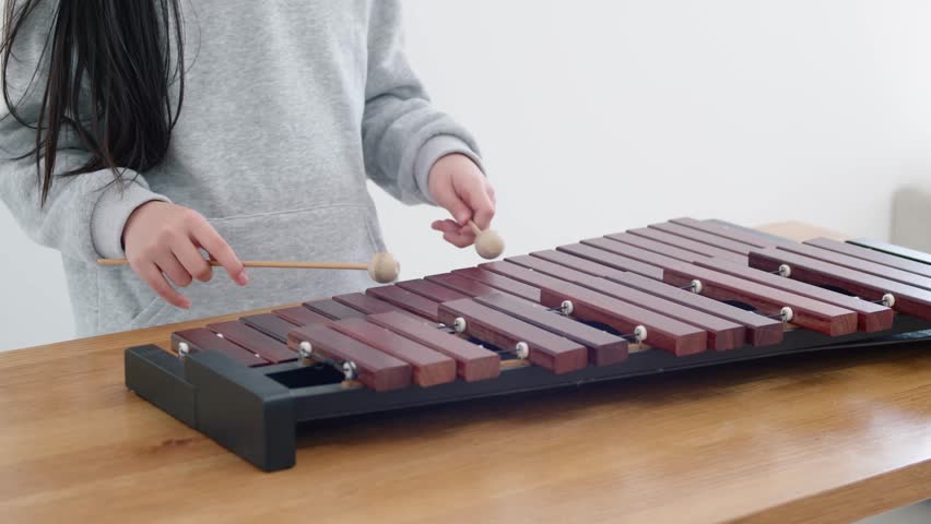 Girl practicing xylophone, 10 years old, elementary school student