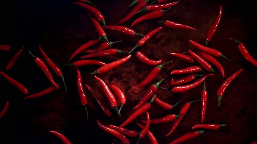 Red chili peppers fly up and fall down. Filmed on a high-speed camera at 1000 fps. High quality FullHD footage