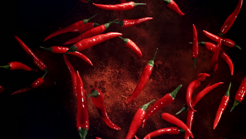 Red chili peppers fly up and fall down. Filmed on a high-speed camera at 1000 fps. High quality FullHD footage