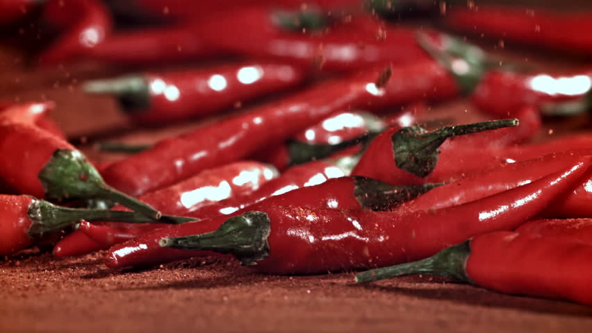 Ground red pepper falls on the table. Filmed on a high-speed camera at 1000 fps. High quality FullHD footage