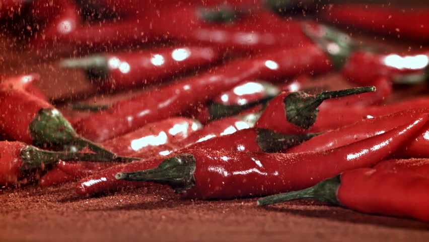 Ground red pepper falls on the table. Filmed on a high-speed camera at 1000 fps. High quality FullHD footage