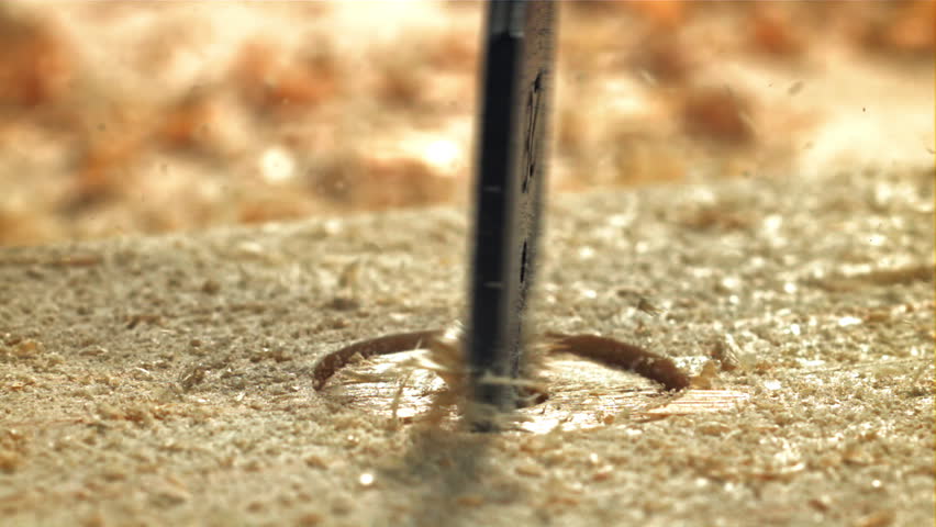 A carpenter drills a hole in a wooden product. Filmed on a high-speed camera at 1000 fps. High quality FullHD footage