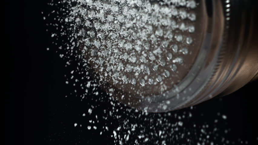 Salt is pouring out of the salt shaker. Filmed on a high-speed camera at 1000 fps. High quality FullHD footage