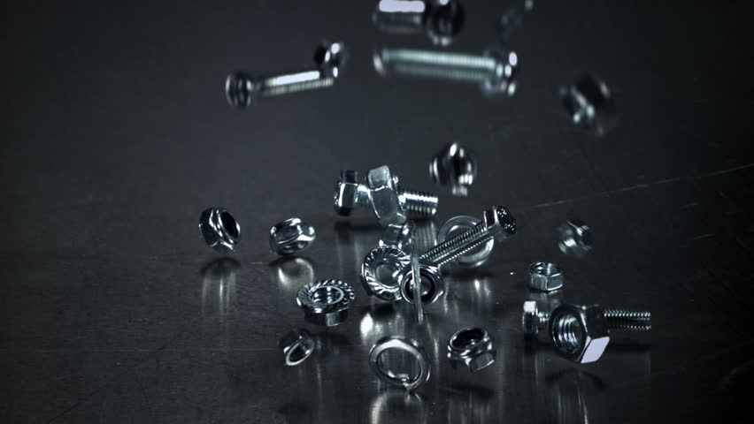 Falling nuts, bolts and washers on a metal table. Filmed on a high-speed camera at 1000 fps. High quality FullHD footage