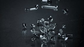 Falling nuts, bolts and washers on a metal table. Filmed on a high-speed camera at 1000 fps. High quality FullHD footage - Powered by Shutterstock - Get 15% off with code: PIKWIZARD15