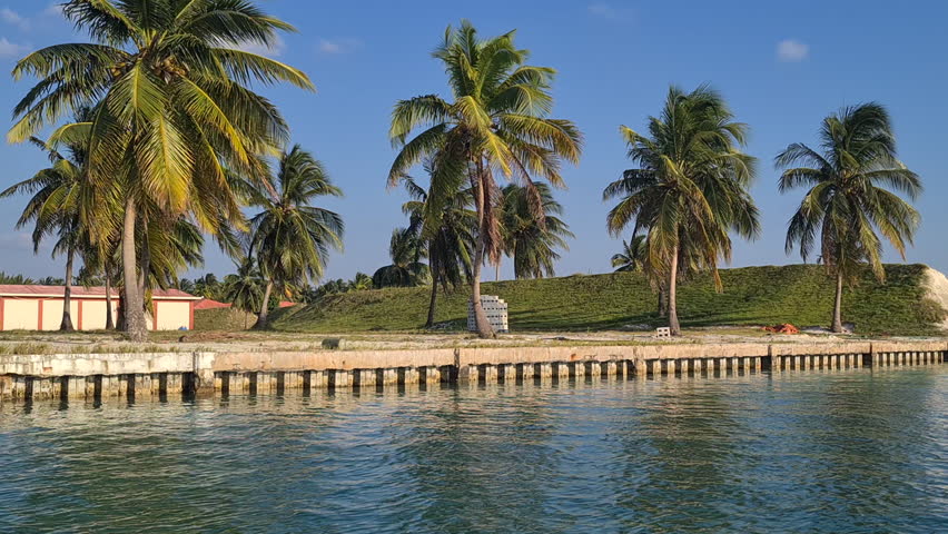Coast of Island in Belize Archipelago, Palm Trees and Construction Site on Caye Chapel
