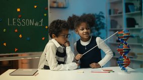African American boy and girl with pointer examine DNA molecule model in school - Powered by Shutterstock - Get 15% off with code: PIKWIZARD15
