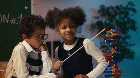 Schoolgirl pointing at DNA molecule model, explaining structure to her friend - Powered by Shutterstock - Get 15% off with code: PIKWIZARD15