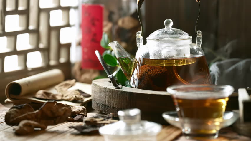 Tangerine peel tea is delicious and refreshing, Hot Healthy herbal tea brewed from red herbs and fruits Into Glass Cup With Steam