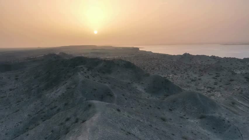 Aerial View of Desert Landscape at Sunset, Rugged Terrain, Rocky Hills