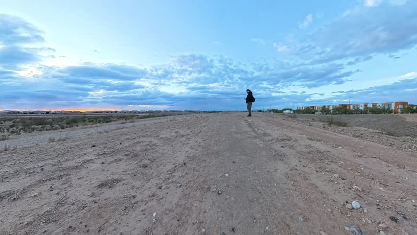 Photographer in Storm Clouds time lapse at sunset in Gilbert Arizona.