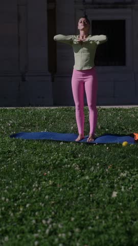 Engaging in an Outdoor Yoga Practice Surrounded by a Lush Green Park Environment
