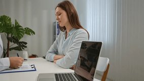 A patient is consulting with a doctor in a modern, well-lit medical office. The setting is professional, featuring medical equipment and documents. - Powered by Shutterstock - Get 15% off with code: PIKWIZARD15