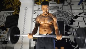 Muscular sportsman performing intense barbell curl exercises at modern gym. Athletic guy doing hard workout at sport club. Sporty man training at fitness centre. Close up - Powered by Shutterstock - Get 15% off with code: PIKWIZARD15