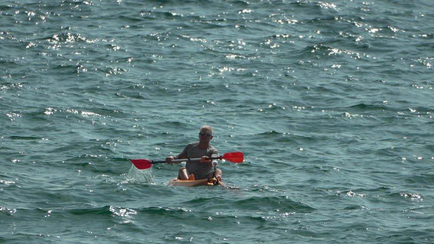 Kayaking Ocean Water Sport - Man paddling kayak on a choppy ocean.