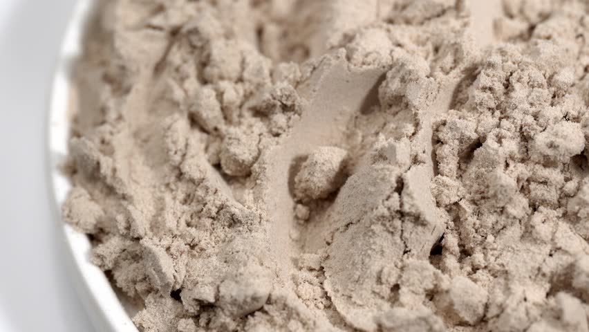 Protein powder in a measuring spoon. Bodybuilding, fitness and lifestyle in the gym. The concept of sports, health and nutrition	
