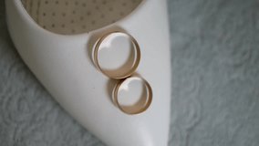 Wedding gold rings on white shoe - Powered by Shutterstock - Get 15% off with code: PIKWIZARD15