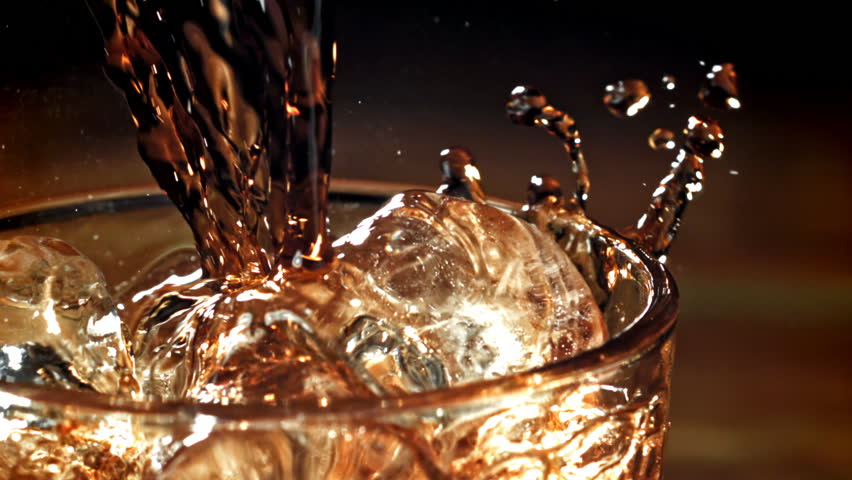 Cola is poured into a glass with ice. Filmed on a high-speed camera at 1000 fps. High quality FullHD footage