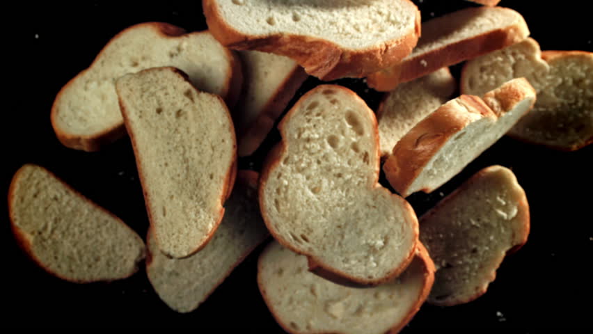 Sliced pieces of bread fly up and fall down. Filmed on a high-speed camera at 1000 fps. High quality FullHD footage