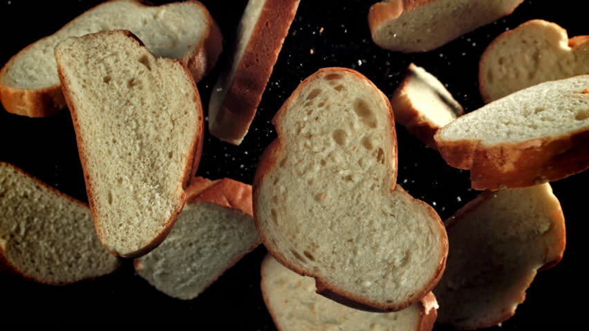 Sliced pieces of bread fly up and fall down. Filmed on a high-speed camera at 1000 fps. High quality FullHD footage