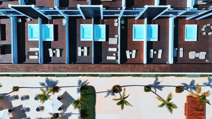 Aerial luxury resort landscape, resort hotel swimming pool, leisure background. Panoramic drone view of hotel swimming pool. Summer vacation in Dominican Republic. Mini pools, drone view.