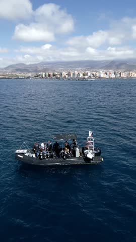 Divers preparing for scuba diving from boat near coast
